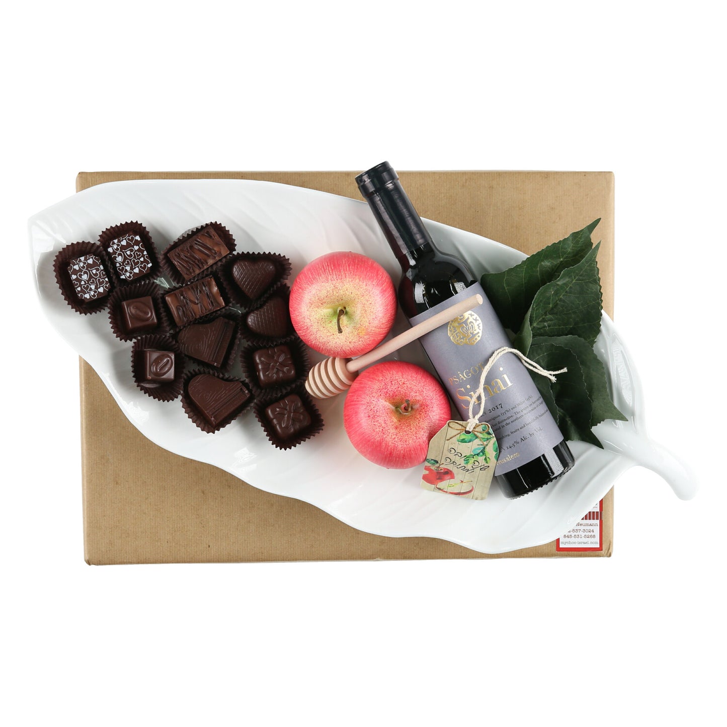 Stunning white ceramic leaf-shaped deep dish filled with Rosh Hashana goodies