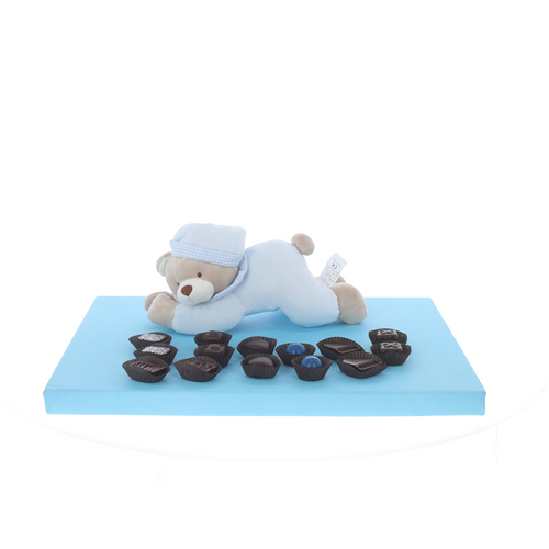 Blue lying teddy with display of Belgian chocolates