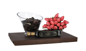 Stunning glass bowl filled with Belgian chocolates, bottle of chocolate liquor, and bouquet of fake tulips
