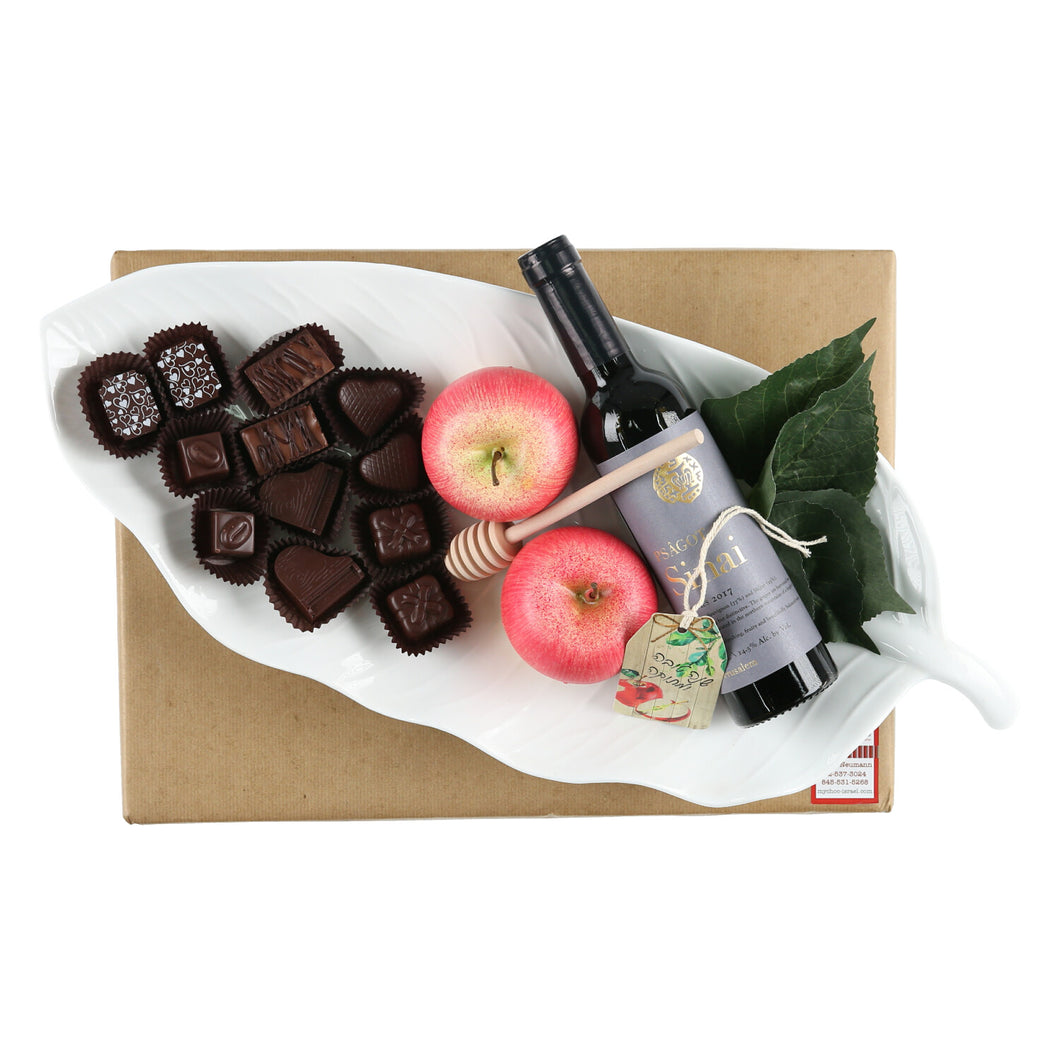 Stunning white ceramic leaf-shaped deep dish filled with Rosh Hashana goodies