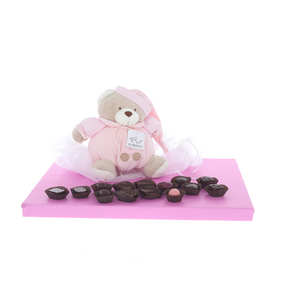 Plush baby toy with music playing pull-string surrounded by delicious Belgian pralines - Girl